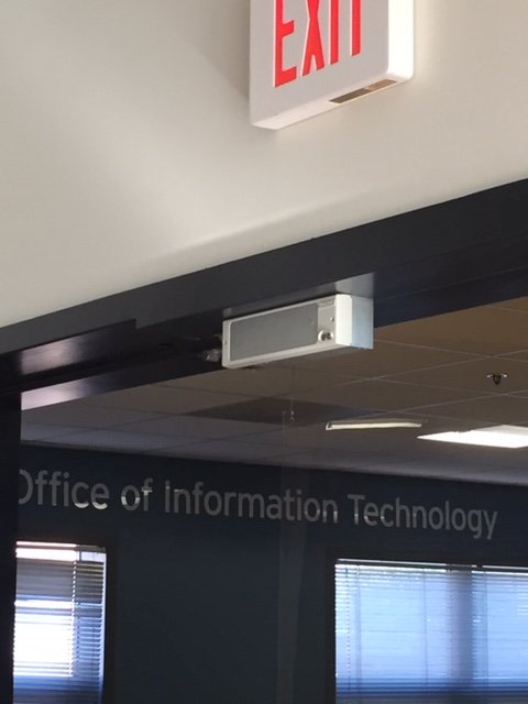 A wall with "Office of Information Technology" written in silver letters
