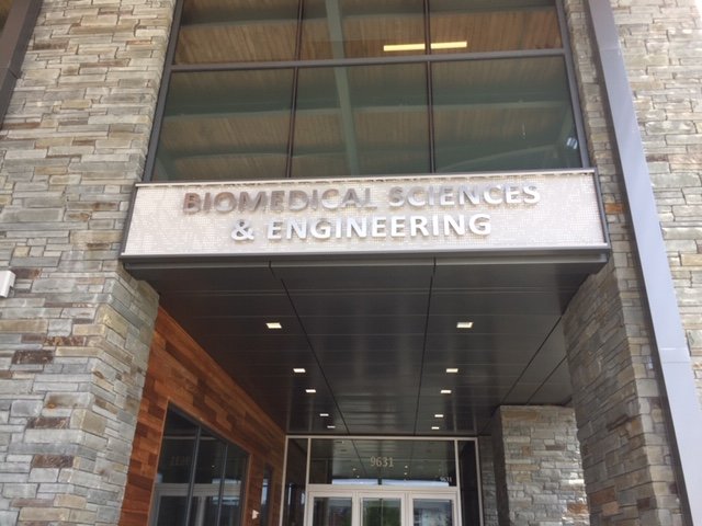 The entrance of a stone and metal building.