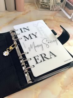 This may contain: a black and white book with writing on it